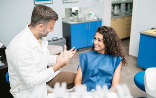 Referral program: Patient talking with dentist