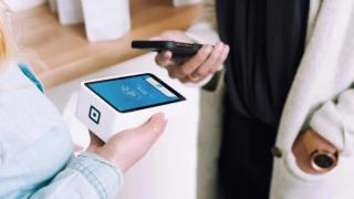 Patient using phone to pay for dental treatment with Afterpay